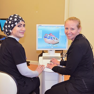Dentists examine teeth on computer